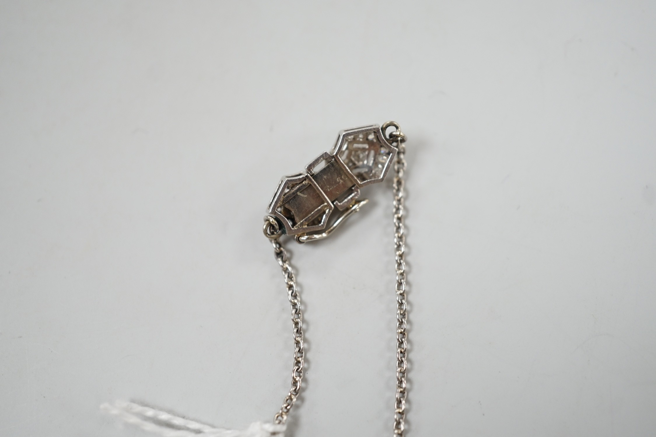 An early to mid 20th century white metal, baguette and round cut diamond set clasp chain, approx. 38cm (knot), gross weight 7.4 grams.